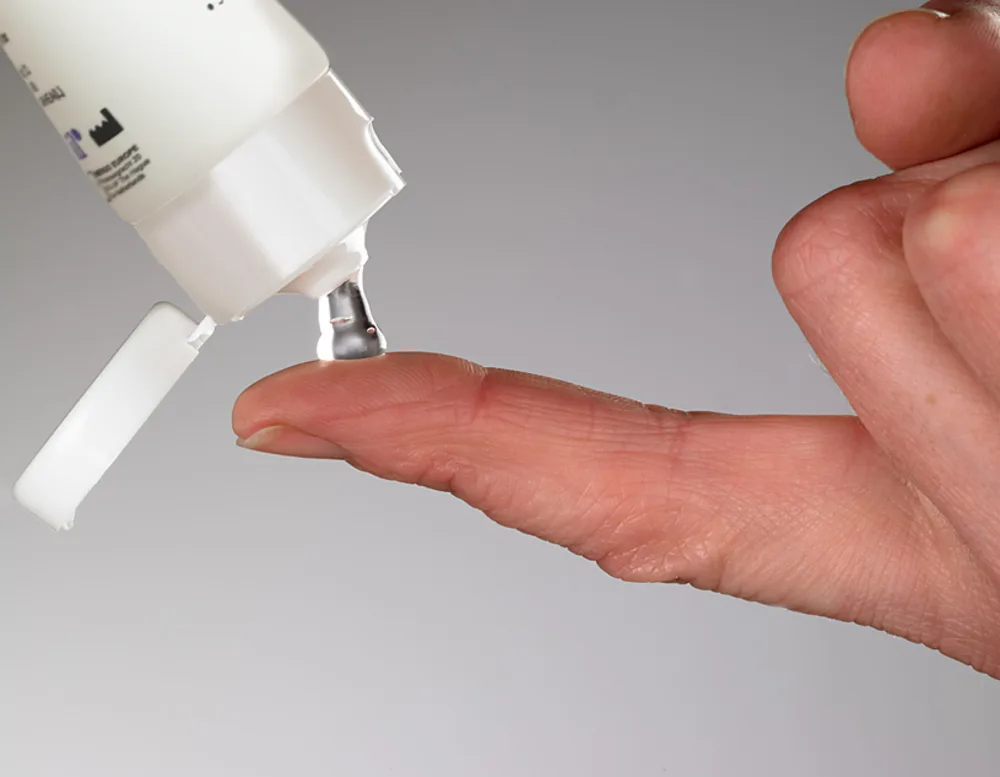 ScarSil silicone scar gel being squeezed onto a finger